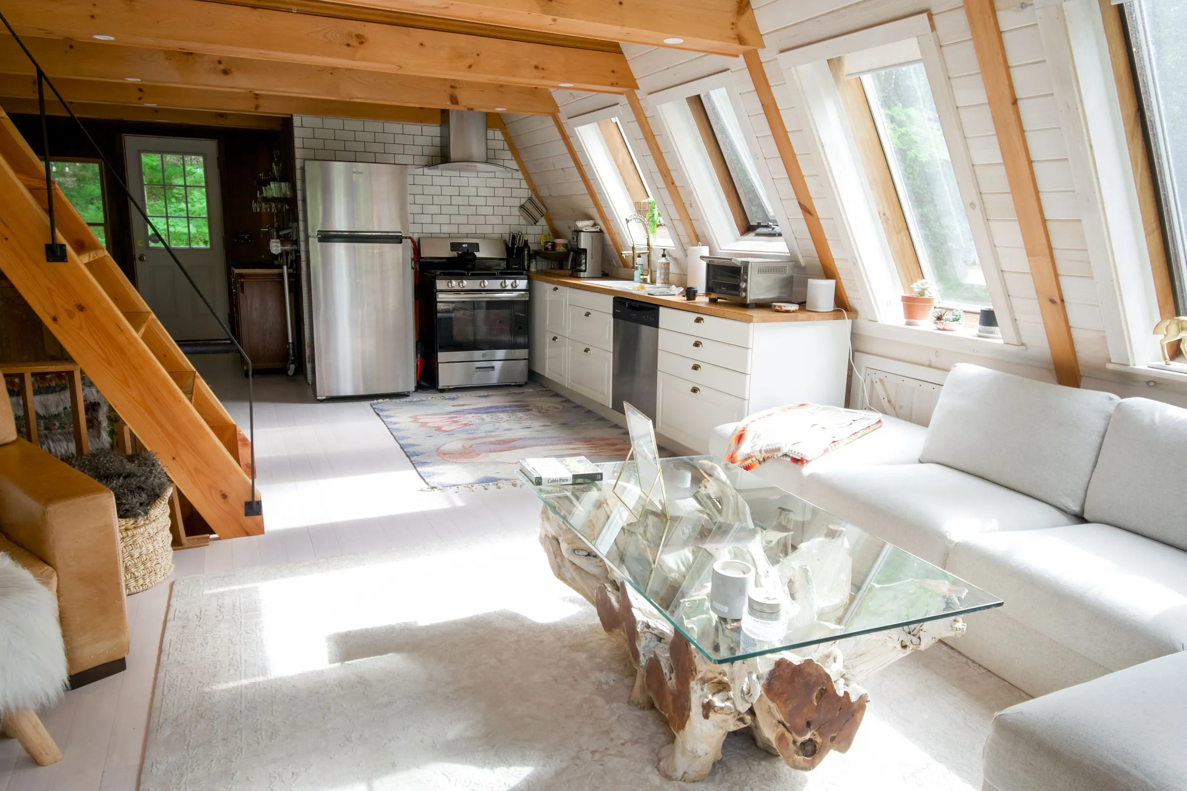 An open kitchen and sitting area under a timber roof