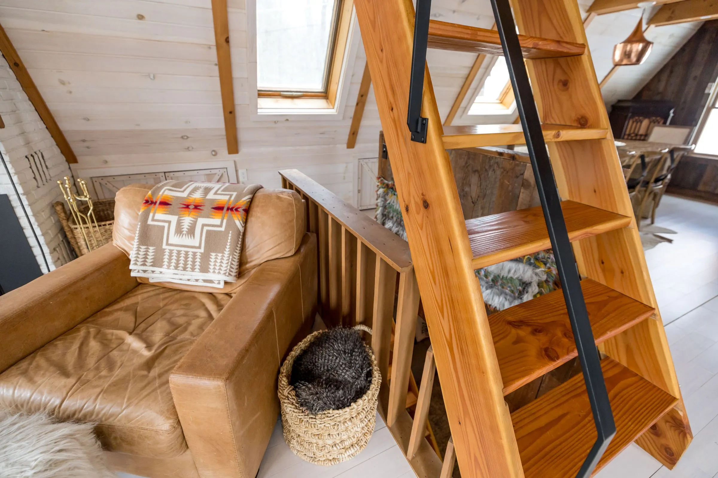 A wooden ladder up to a sleeping loft